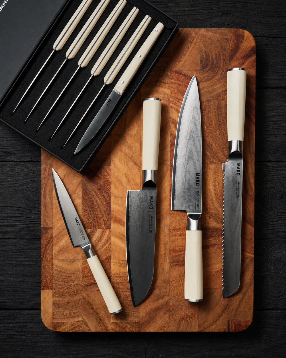MAKO Japanese Steel Cream 8″ Bread Knife CookDineHost with other knives in the range on wooden chopping board