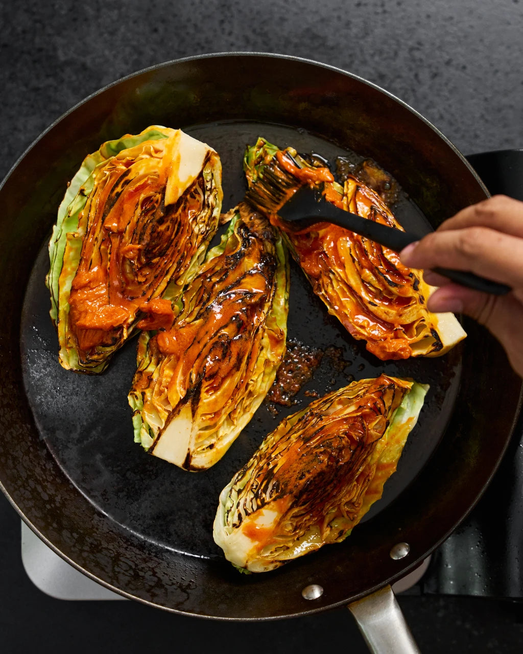 Charred Gochujang Butter Cabbage with Crunchy Breadcrumbs recipe - brush the gochujang paste onto cappage