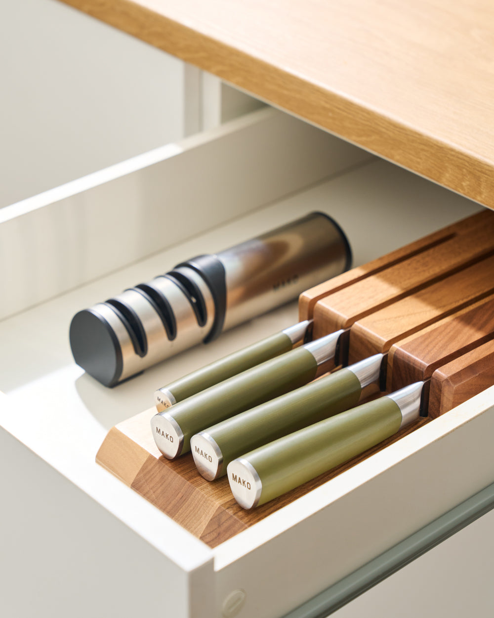 MAKO Japanese Steel Knife Set of 4 - Olive Green In Drawer with sharpener next to it 