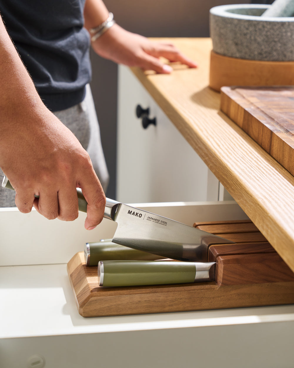 MAKO Japanese Steel Knife Set of 4 - Olive Green In Drawer lifting chef knife out of block side view white drawer
