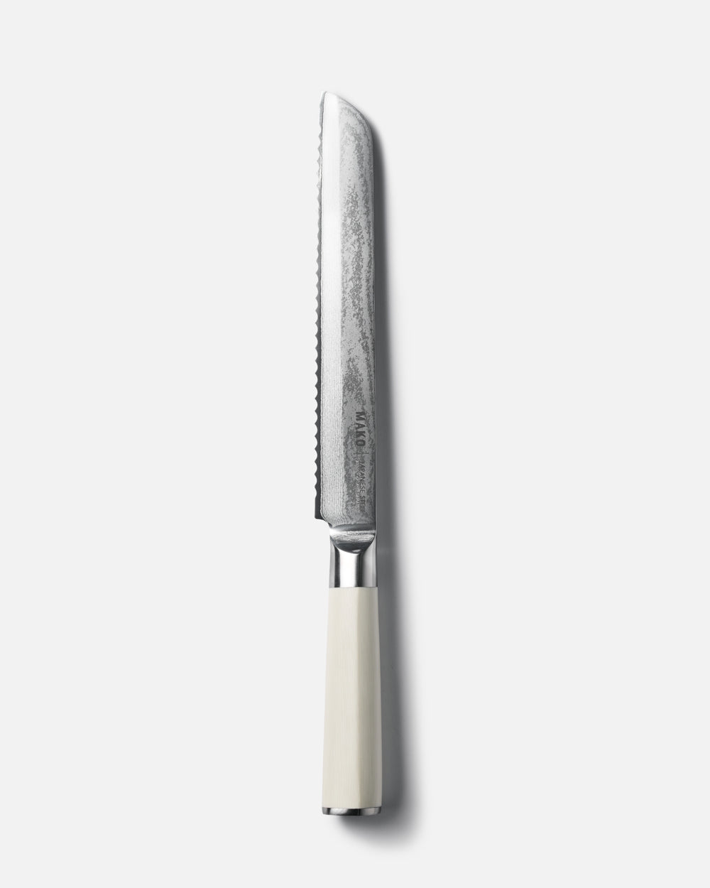 MAKO Japanese Steel Cream 8″ Bread Knife on white background vertical alignment tip upwards