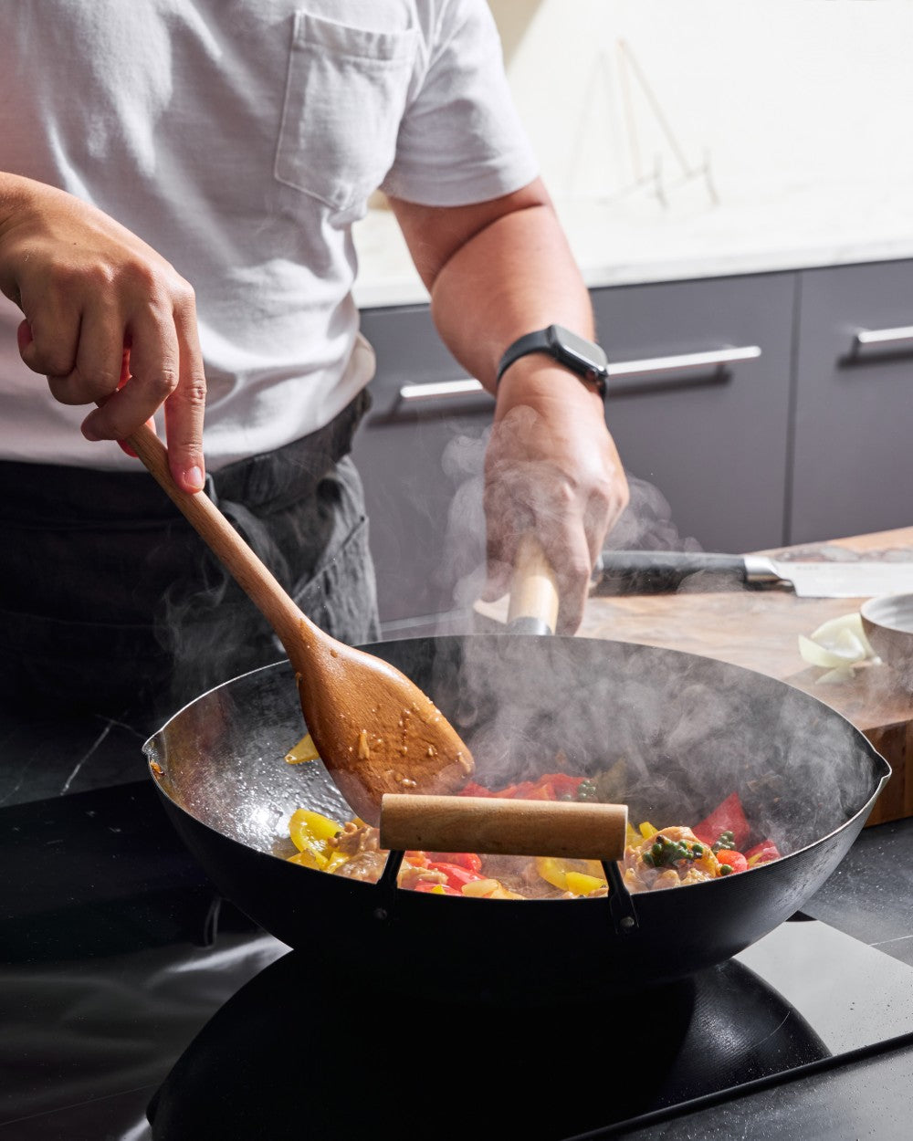 MAKO Black Steel Wok Kit on induction stove in use stir-fry CookDineHost