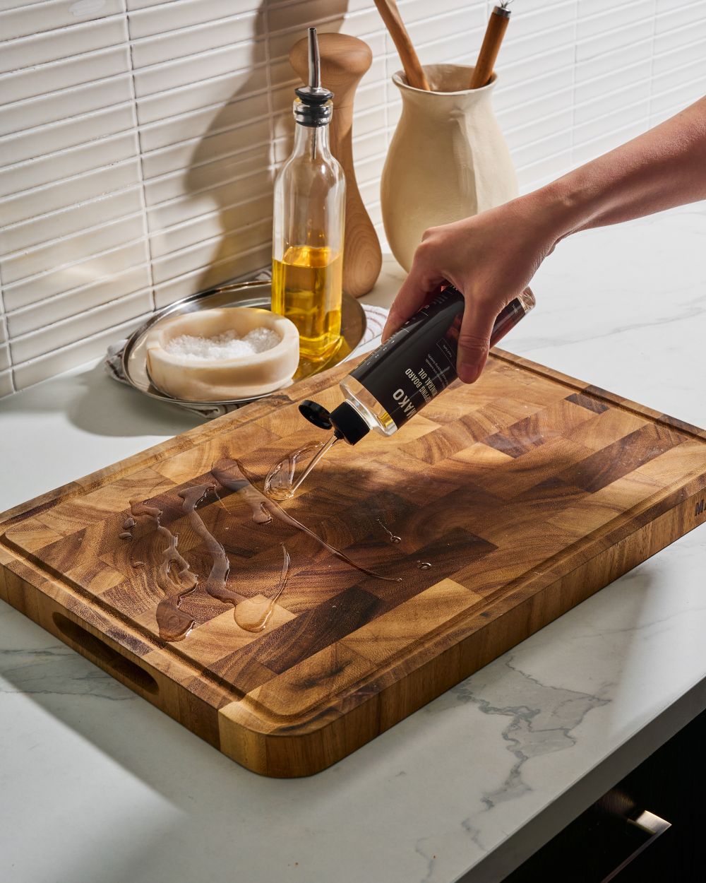 MAKO Chopping Board Mineral Oil in use on the MAKO Master Board. Using oil on board on white kitchen bench top