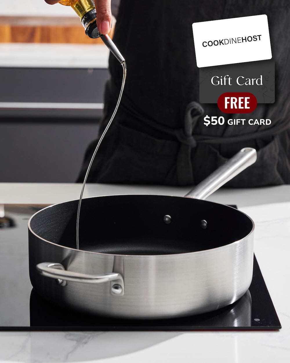MAKO Genius 5-Ply 26cm Non-Stick Saute Pan With Lid pouring oil into pan on stovetop 50 gift card promo