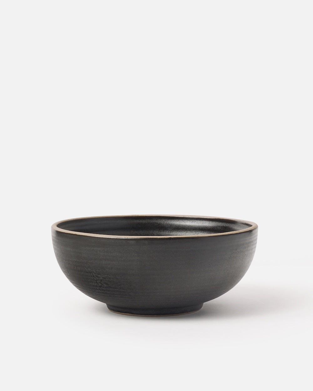 Charcoal ceramic cereal bowl with a matte finish on a plain white background
