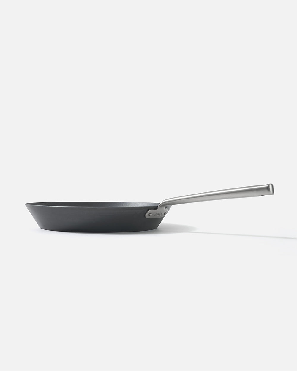 Nonstick black skillet with stainless steel handle on white background, side view