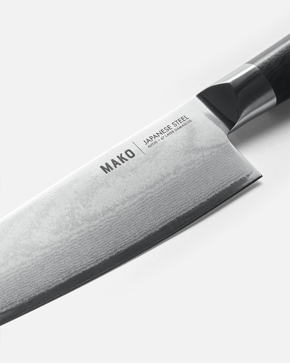 Close-up of MAKO Santoku knife with Japanese steel and Damascus 47-layer blade on white background