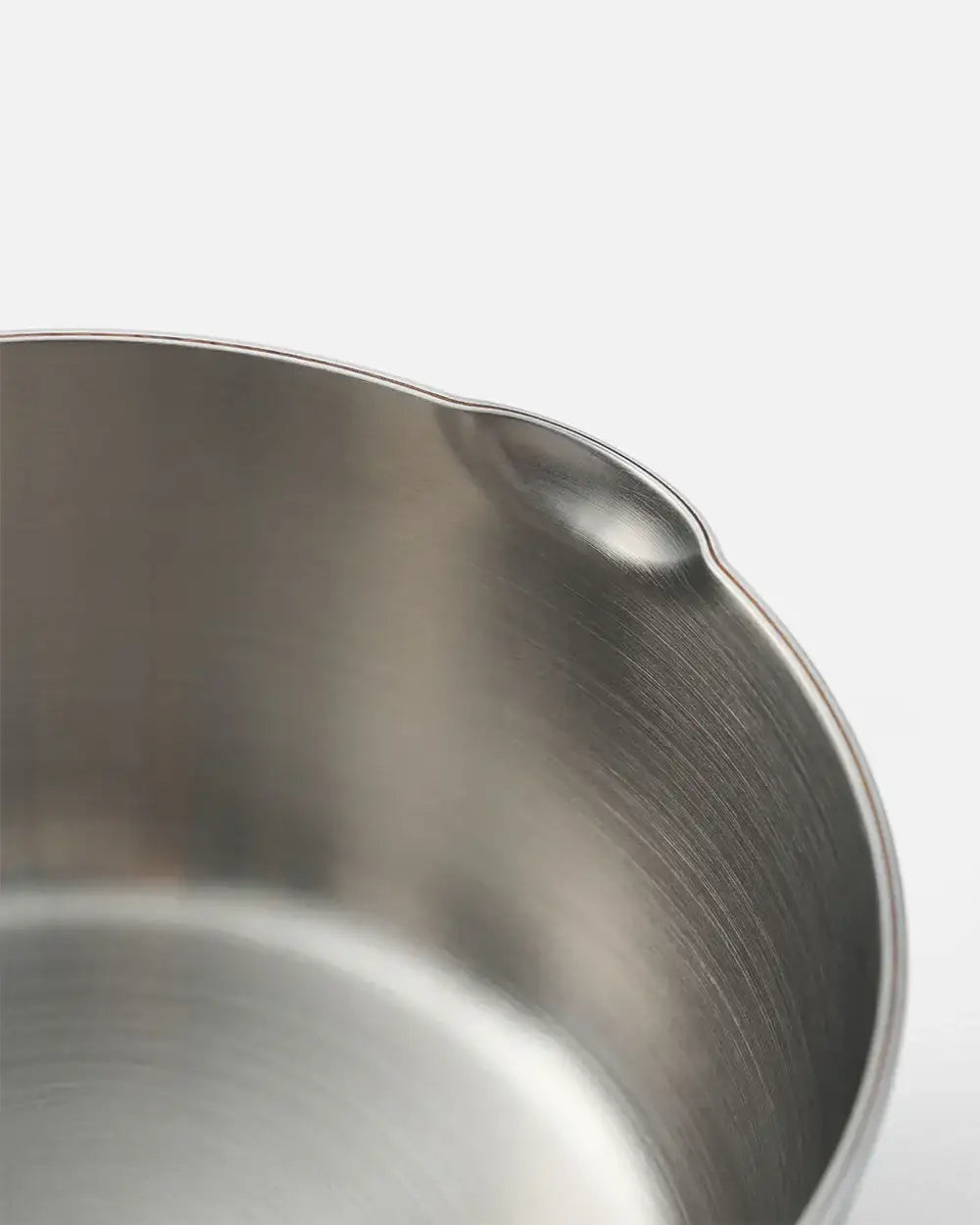 Close-up of Mako stainless steel kitchen bowl with pour spout, sleek brushed finish