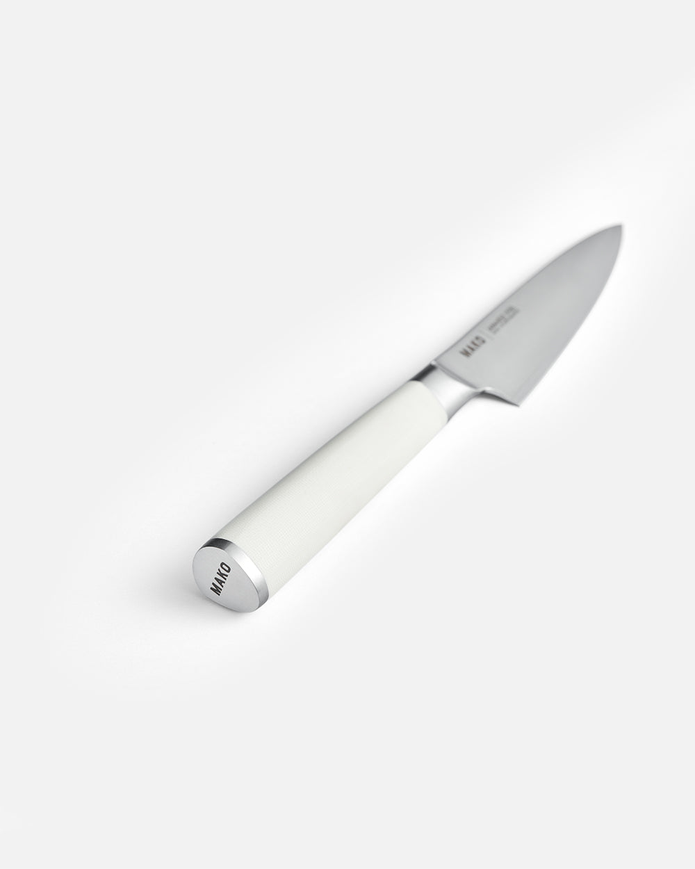 Stainless steel utility knife with cream handle on white background, MAKO engraved on end cap