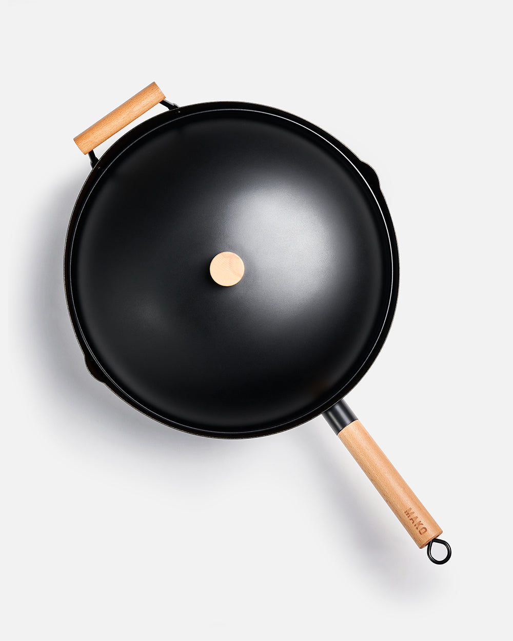 Black wok with wooden handles and lid on a white background, nonstick cookware