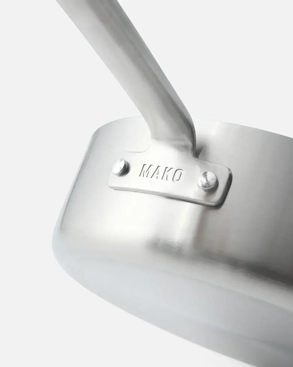 Close-up of stainless steel saucepan handle with MAKO branding by chef Marion Grasby