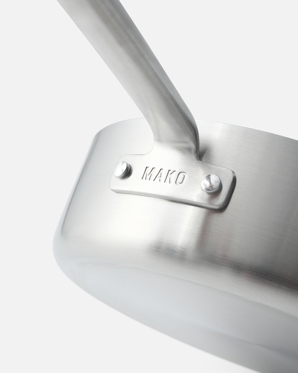 Close-up of stainless steel sauté pan with sturdy handle and visible MAKO engraving