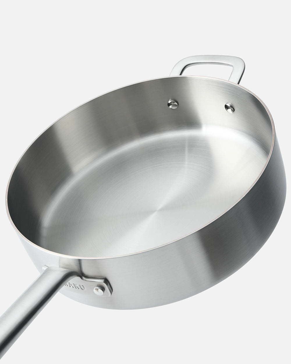 Stainless steel sauté pan with long handle and helper handle on white background