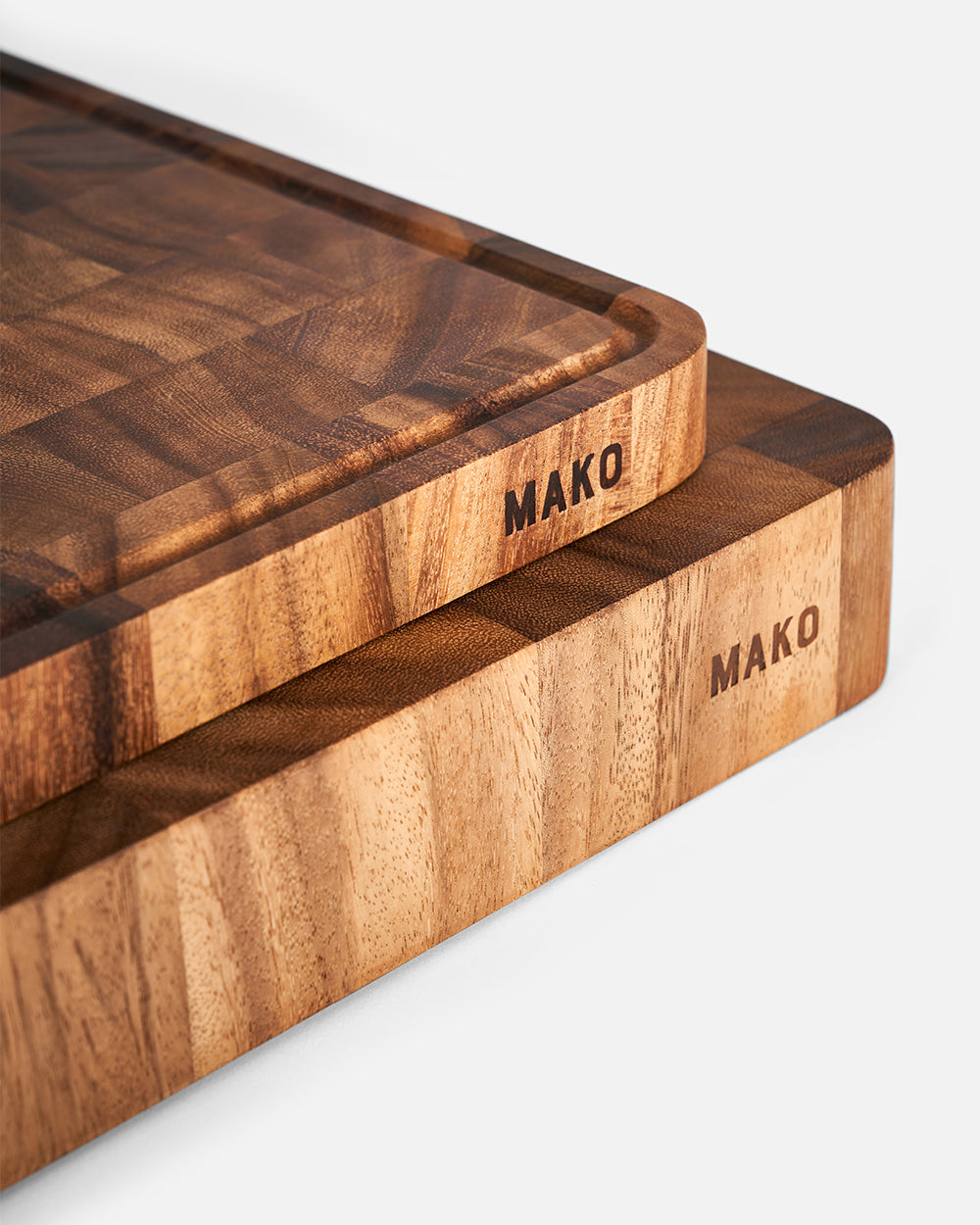 Set of two thick wooden chopping boards with MAKO logo and juice groove detail