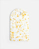 Marion Grasby lemon speckled cutting board with rounded top and hanging hole on white background