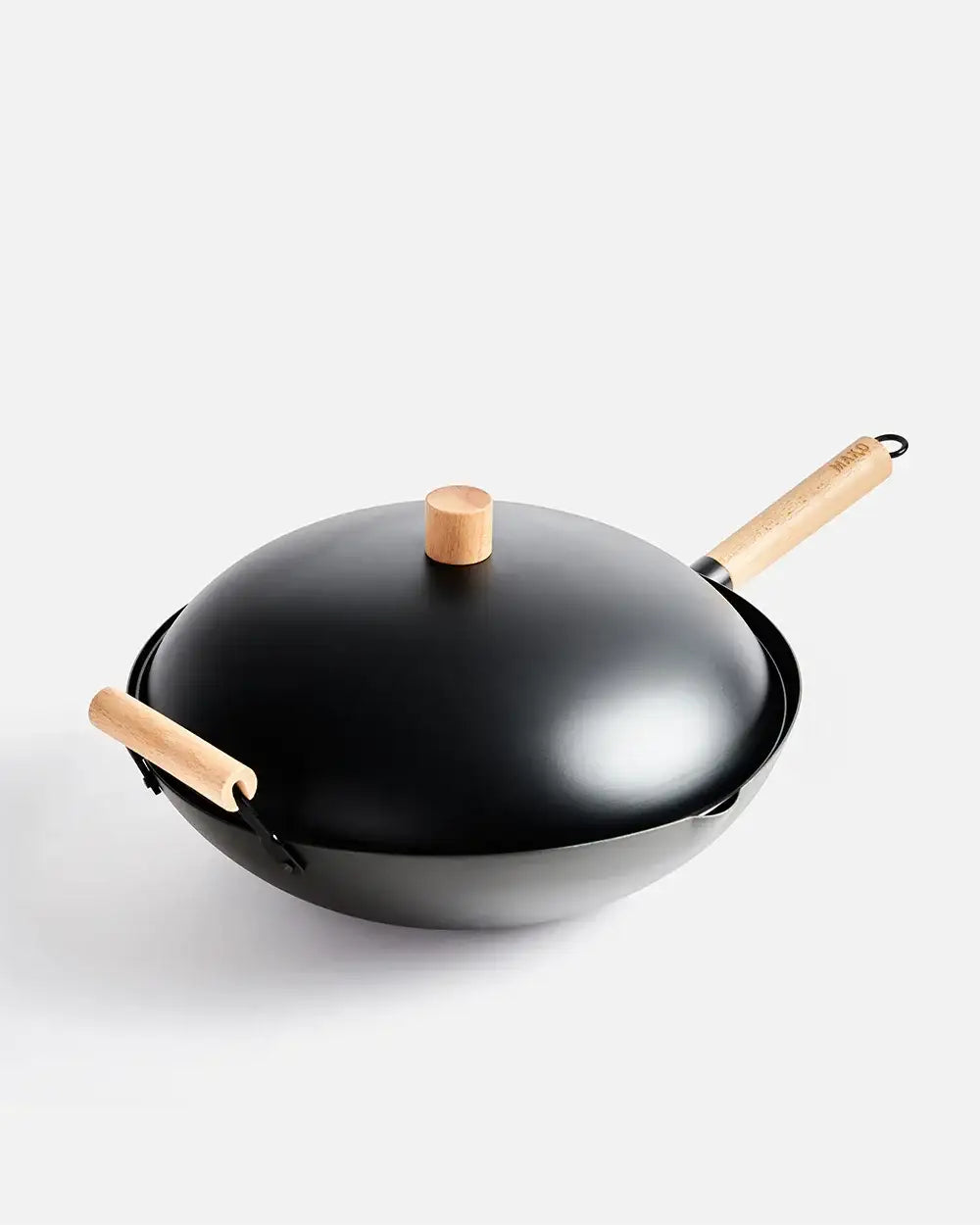 Black wok with wooden handles and lid knob, modern Asian cookware by Marion Grasby