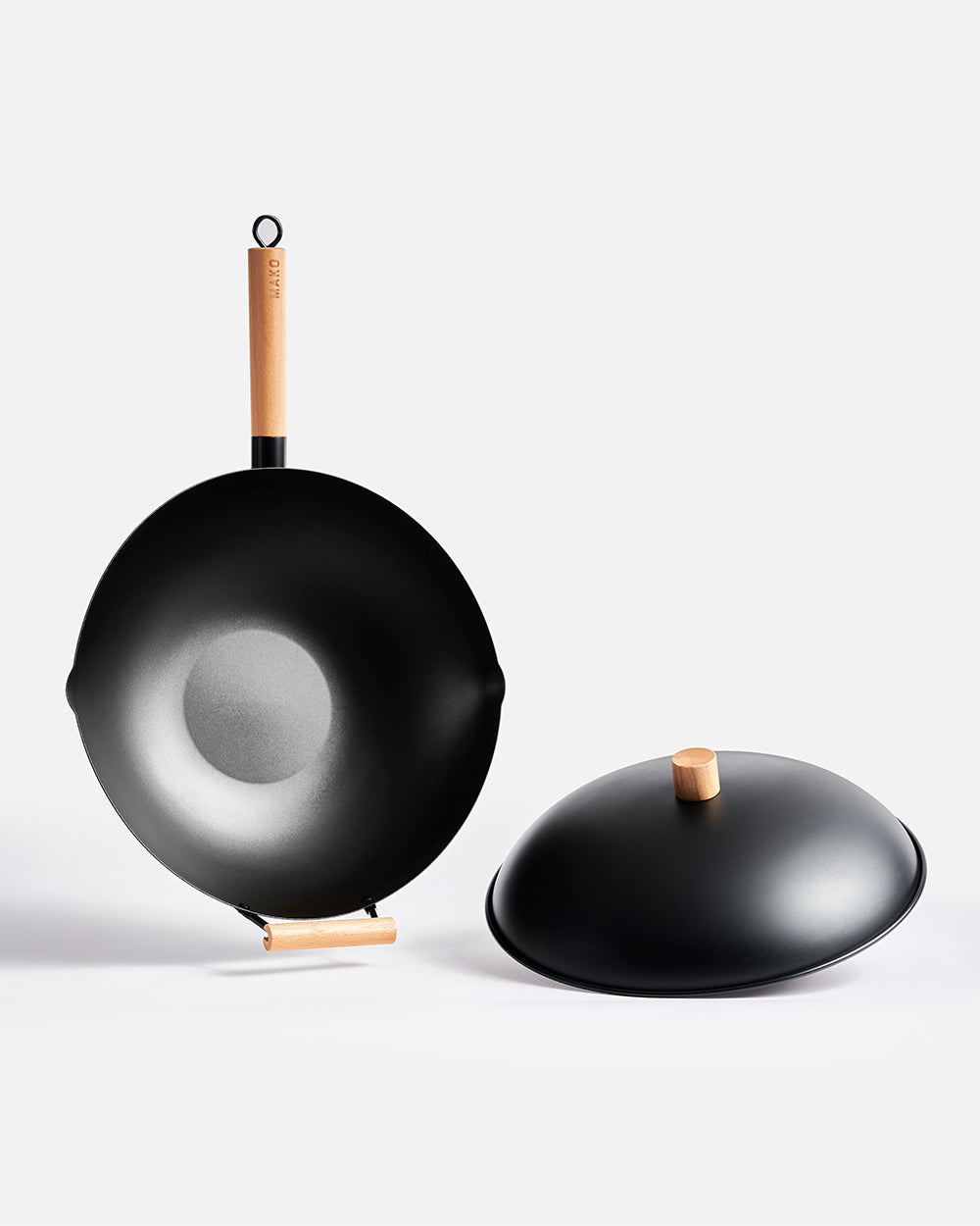 Nonstick black wok with wooden handle and matching lid, modern kitchen cookware set.