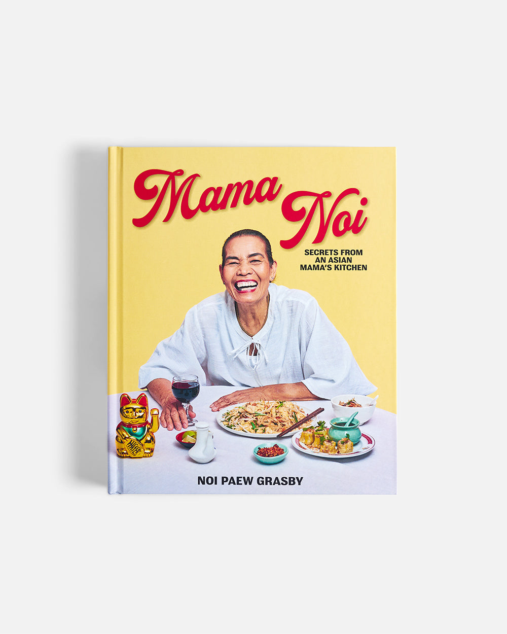 Mama Noi Asian cookbook cover featuring a smiling woman, Asian dishes, and tableware