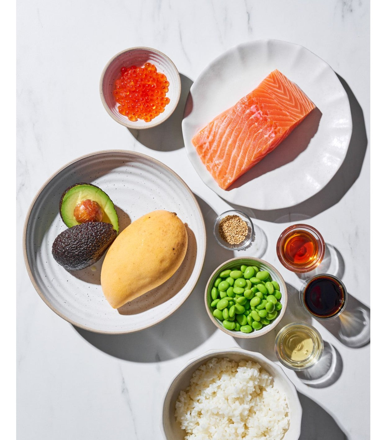 Salmon Poke Bowl ingredients flat on marble bench CookDineHost