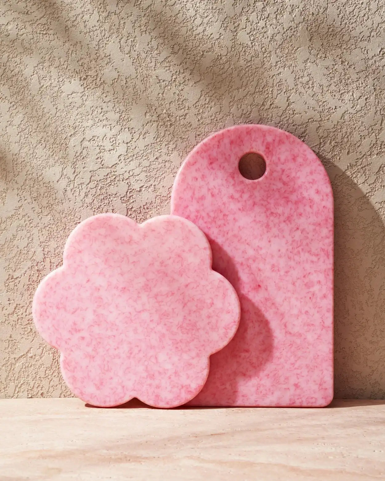 Pink Sasni Fairy Floss Duo cutting boards by Marion Grasby, styled against textured beige wall