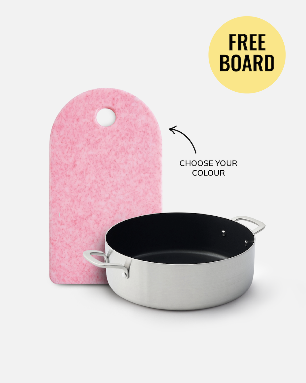 A pink felt cutting board with a hole at the top stands next to a stainless steel pot with a black interior on a light gray background. A yellow circle in the top right says 'FREE BOARD' and an arrow points to the board with the text 'CHOOSE YOUR COLOUR'.