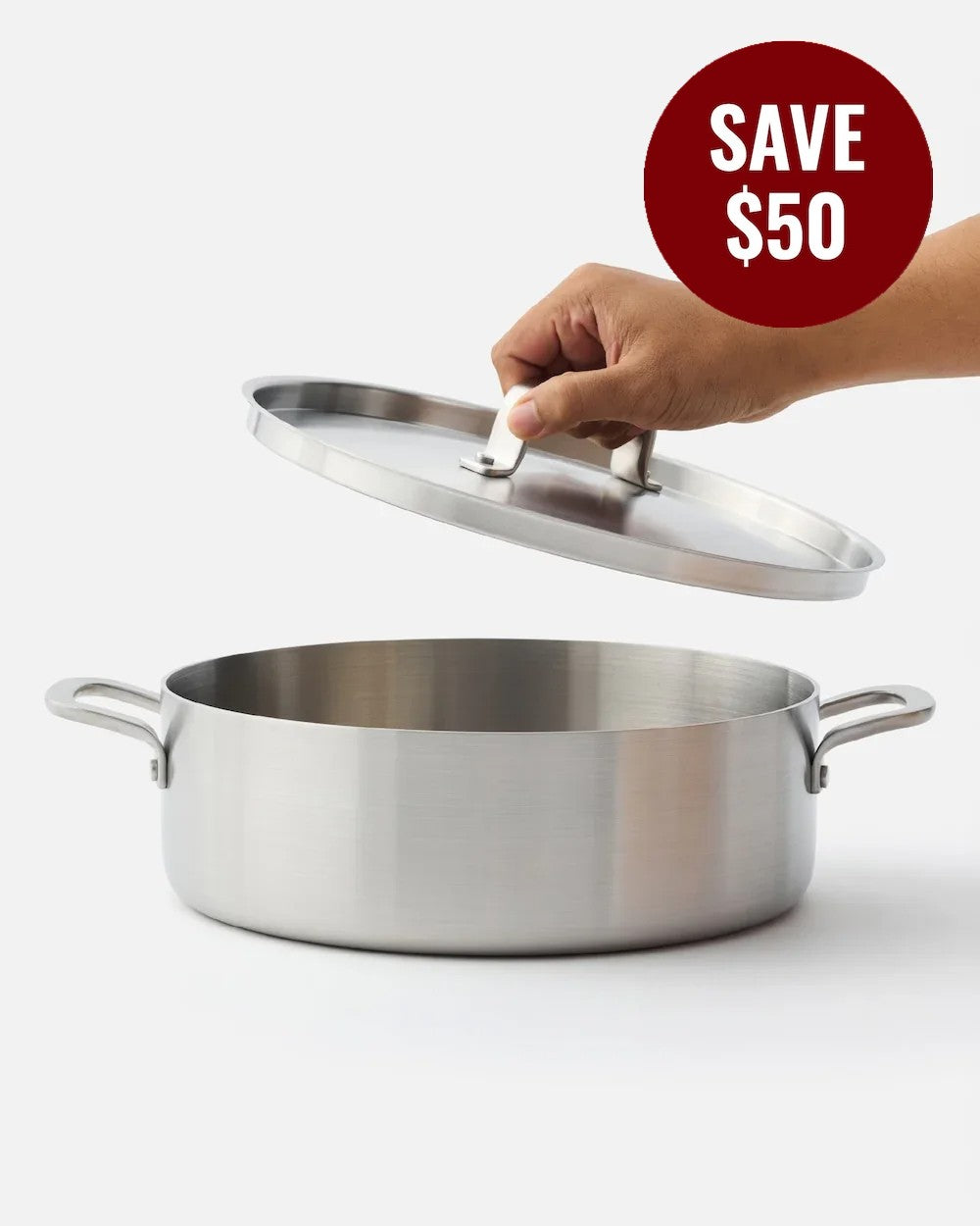 MAKO Genius 5-Ply 28cm Essential Pan With Lid on a white background, hand holding the lid, and 'Save $50' label.