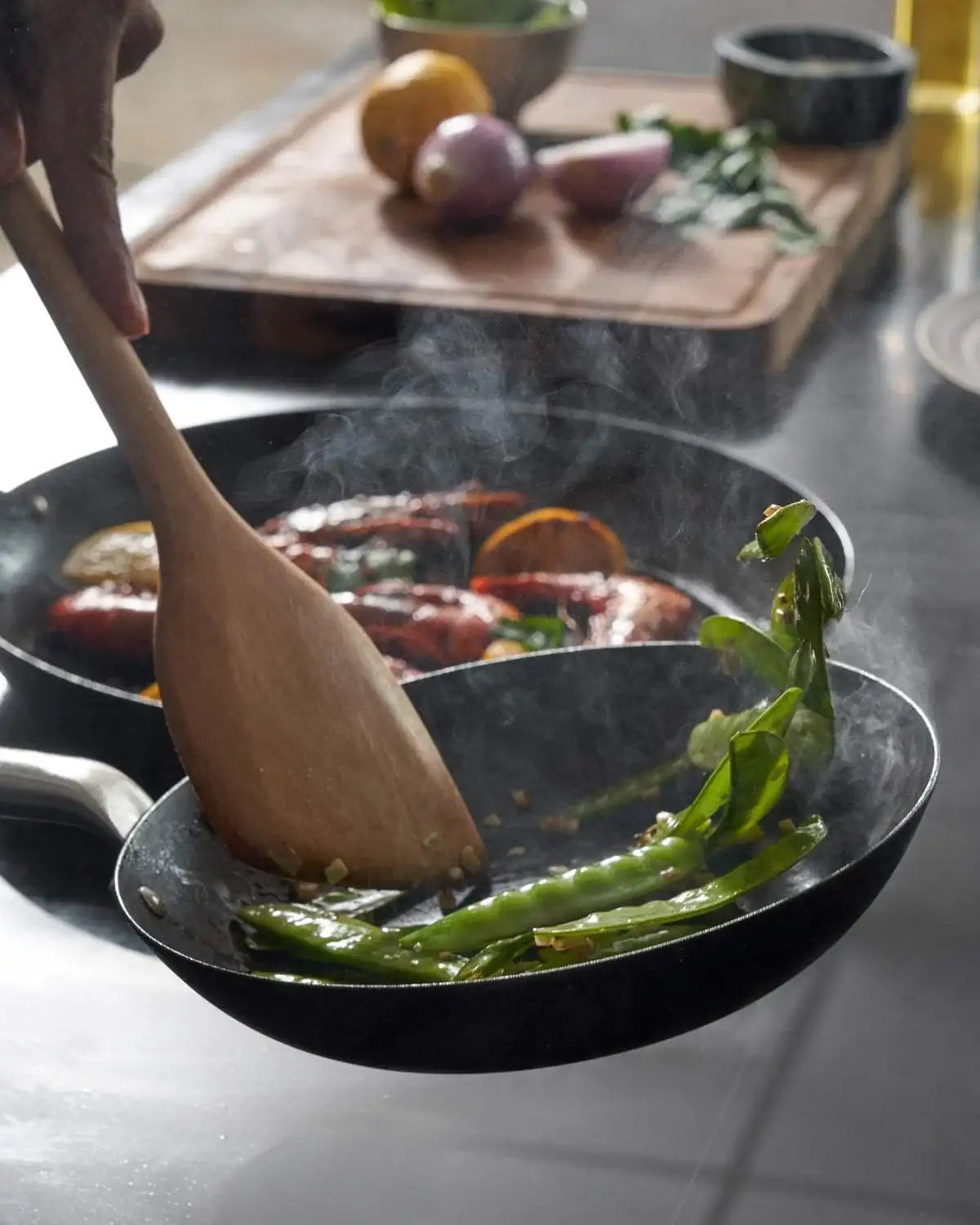 Mako black steel 20cm frying pan by Marion Grasby with sautéed green beans and shrimp on stovetop