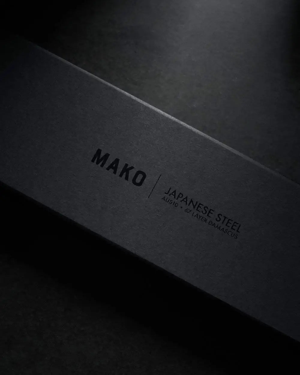 Black textured box with MAKO Japanese steel AUS10 67 layer Damascus text, premium knife packaging