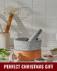 Mako granite mortar and pestle on wooden base with spices and garlic for kitchen cooking