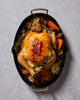 Oven-roasted whole chicken with vegetables in a non-stick oval roasting pan
