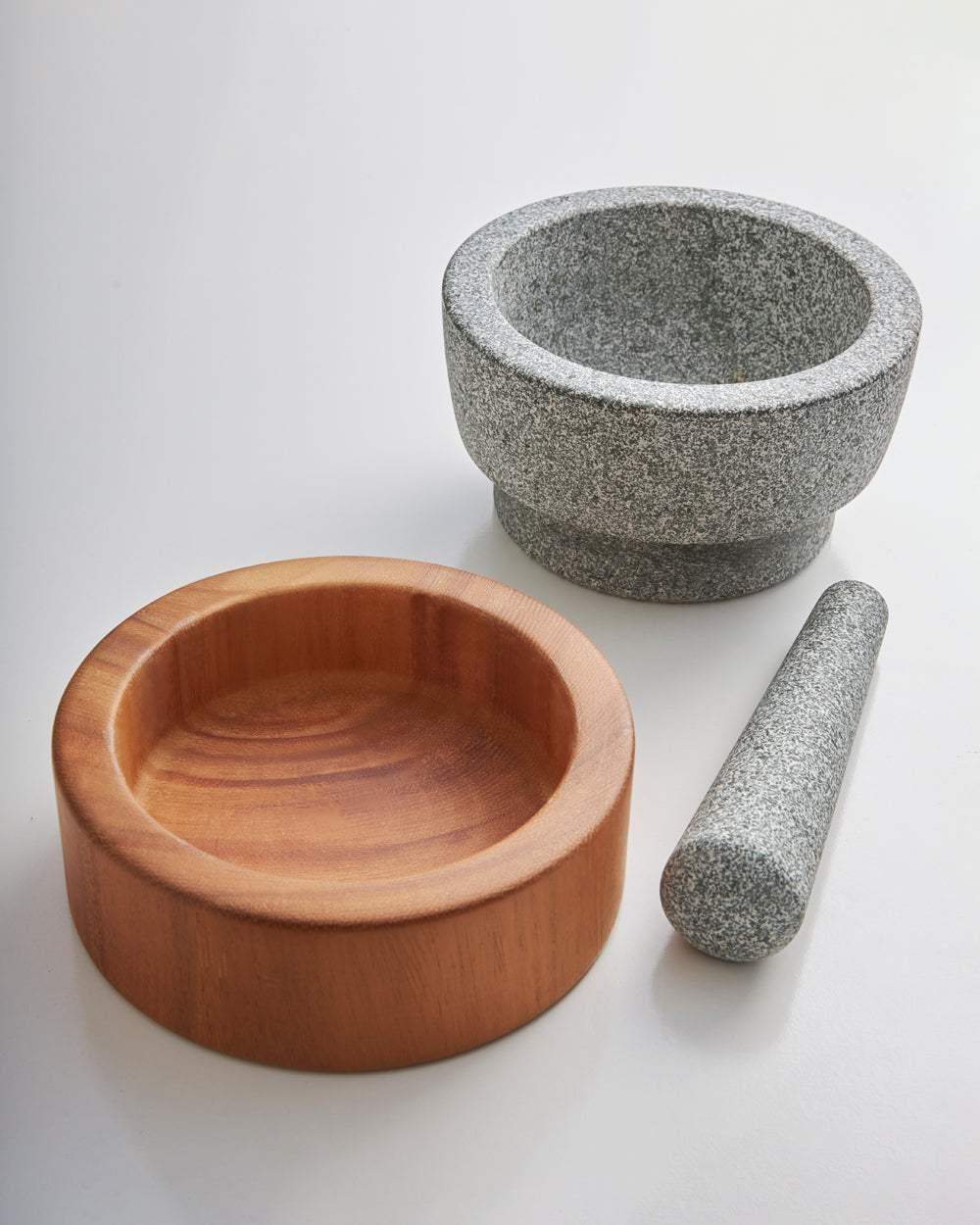 Marion Grasby Mako granite mortar and pestle with wooden bowl on white surface